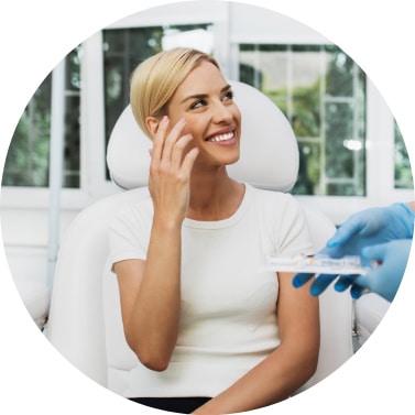 Smiling Woman Sitting On Dental Chair