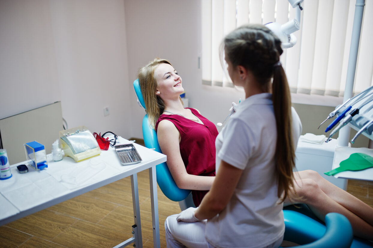 Dentist consulting with a patient during a dental checkup.