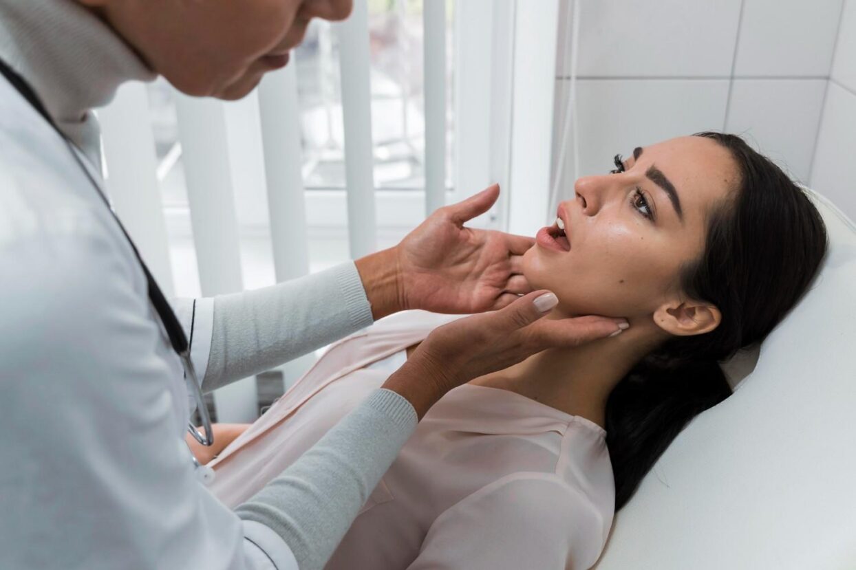 Dentist examining a patient’s jaw during a checkup.